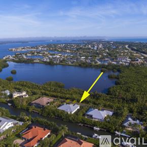 Vero Beach house for rent - A yellow arrow points to a house in a lush green area.