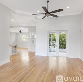Vero Beach house for rent - A spacious room with wooden floors and a ceiling fan.