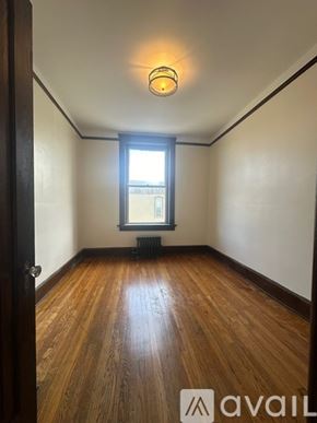 Oswego apartment for rent - A room with wooden floors and a window.