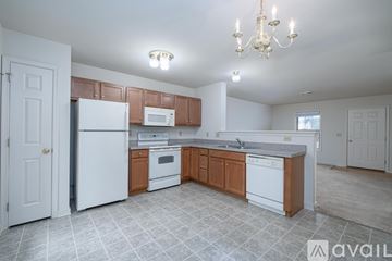 Mountville apartment for rent - A kitchen with white appliances and wooden cabinets.