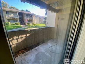 Azusa apartment for rent - A view from inside a room looking out to a building with a flag on it.