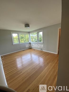 Highland Park apartment for rent - A room with wooden flooring and a window overlooking trees.