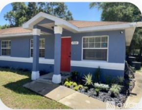 Ocala apartment for rent - A blue house with a red door and a brown roof.