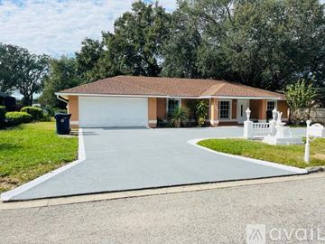 Auburndale apartment for rent - A kitchen with white cabinets and a stainless steel refrigerator.