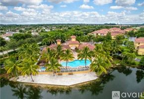 Fort Myers condo for rent - A resort with a pool surrounded by palm trees.