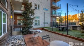 Dallas apartment for rent - A balcony with a table and chairs is attached to a house.