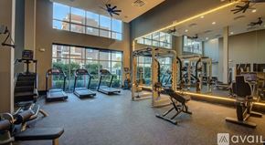 Dallas apartment for rent - A gym with a variety of equipment including treadmills, weights, and exercise machines.