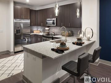 Dallas apartment for rent - A modern kitchen with a large island and stainless steel appliances.