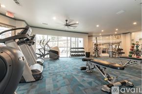 Fort Worth apartment for rent - A gym with a variety of equipment including treadmills, weights, and a ceiling fan.