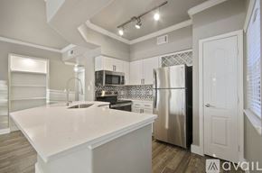 Fort Worth apartment for rent - A kitchen with a white countertop and stainless steel appliances.