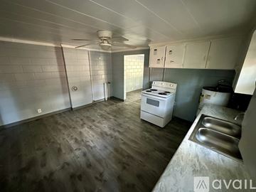 Rocky Mount apartment for rent - A kitchen with a white stove and wooden floors.