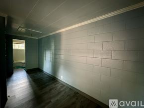 Rocky Mount apartment for rent - A long hallway with a white wall and wooden floor.