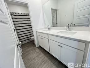 Sacramento apartment for rent - A white toilet in a bathroom with a striped shower curtain.