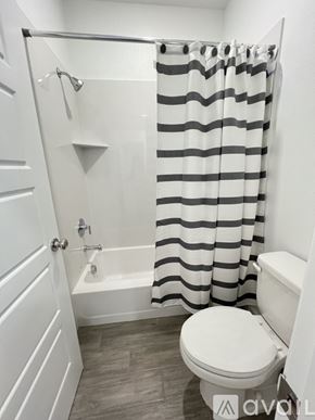 Sacramento apartment for rent - A bathroom with a toilet and a shower curtain.