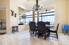 Port Charlotte house for rent - A dining room with a table set for four.