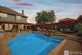 Lewisville house for rent - A swimming pool in a backyard with a house and a fence.