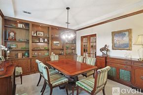 Lewisville house for rent - A dining room with a wooden table and chairs.