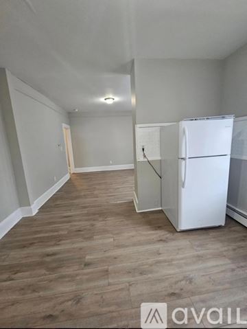New Haven apartment for rent - A white refrigerator is in a kitchen with wood flooring.