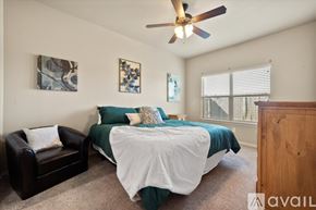 Wolfforth townhouse for rent - A bedroom with a bed, a chair, and two pictures on the wall.