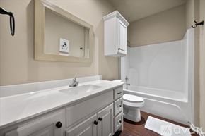 Wolfforth condo for rent - A white bathroom with a sink, toilet, and bathtub.