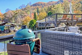 Clayton house for rent - A patio with a hot tub and a mountain in the background.