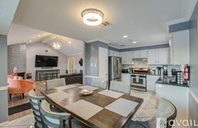 Houston house for rent - A modern kitchen with a dining table and chairs.