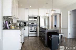 Huntington Beach condo for rent - A modern kitchen with white cabinets and stainless steel appliances.