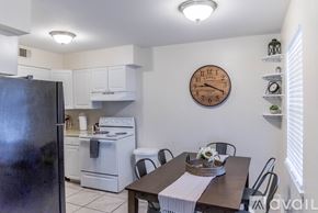 Gulfport apartment for rent - A kitchen with a refrigerator, oven, and dining table.