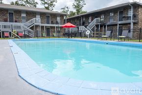 Gulfport apartment for rent - A swimming pool in front of apartment buildings.