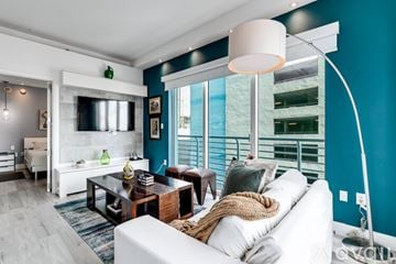 Miami apartment for rent - A living room with a white couch and a wooden coffee table.