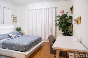 Miami apartment for rent - A bedroom with a bed, desk, and chair.