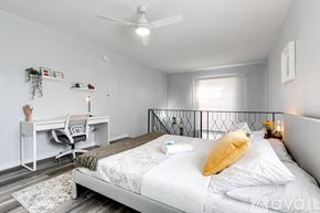 Virginia Gardens apartment for rent - A bedroom with a bed, desk, and chair.