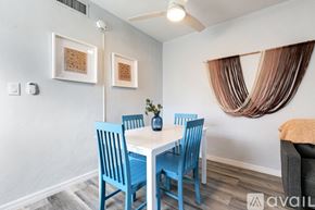 Virginia Gardens apartment for rent - A dining room with a white table and blue chairs.