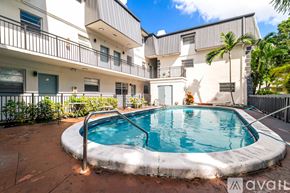 Virginia Gardens apartment for rent - A small pool in a courtyard surrounded by buildings.