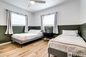 Virginia Gardens apartment for rent - A bedroom with two beds and a ceiling fan.