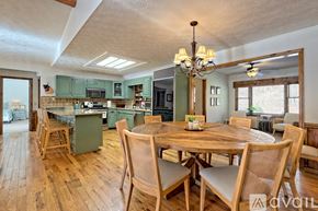 Clayton house for rent - A dining room with a wooden table and chairs.
