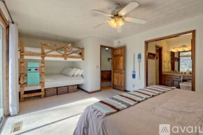 Clayton house for rent - A bedroom with a bed, a bunk bed, and a mirror on the wall.