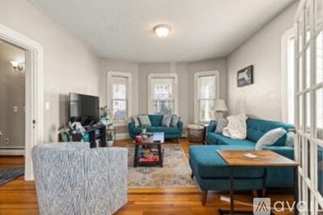 Watertown apartment for rent - A living room with a grey sofa and a grey ottoman.