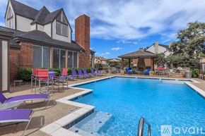 Plano apartment for rent - A pool with chairs around it and a house in the background.