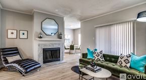 Plano apartment for rent - A living room with a fireplace, a sofa, and a chair.