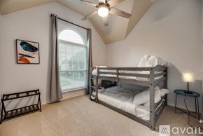 Plano apartment for rent - A bedroom with a bunk bed and a ceiling fan.