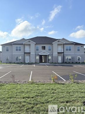 Bowling Green apartment for rent - A large two-story building with a parking lot in front.