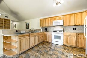 San Marcos apartment for rent - A kitchen with wooden cabinets and a marble floor.