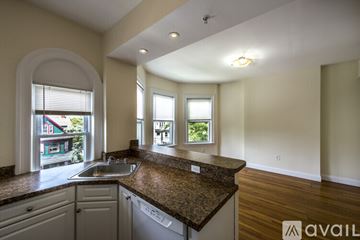 Boston apartment for rent - A kitchen with a granite countertop and a sink is available for rent.
