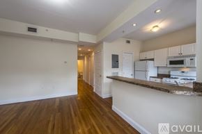 Boston apartment for rent - A kitchen area with white cabinets and a brown countertop.
