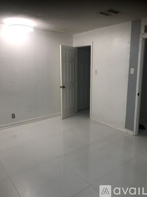 Oakland Park house for rent - A room with a white door and a white wall.
