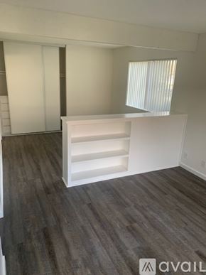 Bakersfield apartment for rent - A room with a white shelf and wooden flooring.