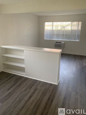Bakersfield apartment for rent - A white shelf unit in a room with a window.