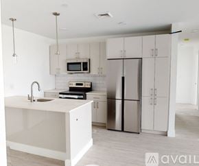 Boston apartment for rent - A modern kitchen with a white countertop and stainless steel appliances.