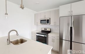 Boston apartment for rent - A kitchen with a sink, stove, and refrigerator.